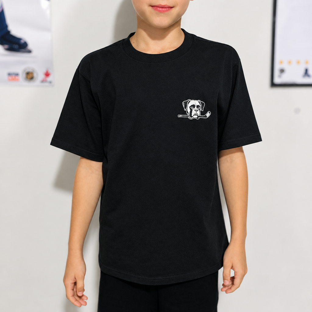 Youth model wearing the Charcoal Youth Hockey T-Shirt, front view, with hockey posters in the background